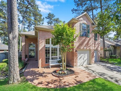 Enjoy brick front patio on wooded lot.