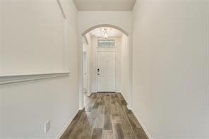 Hall with dark hardwood / wood-style floors