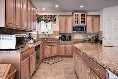 Beautiful cabinets with granite countertops and tile floors