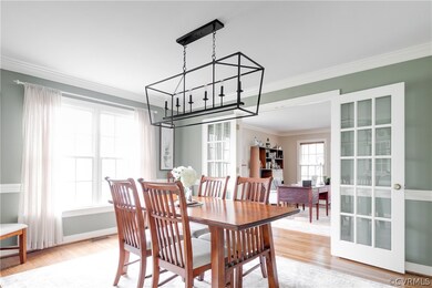 The formal dining room is charming with a new chan