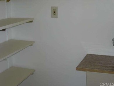 Walk-in pantry & storage room with sink & door to 