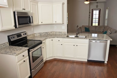 Kitchen with dark hardwood / wood-style flooring, 