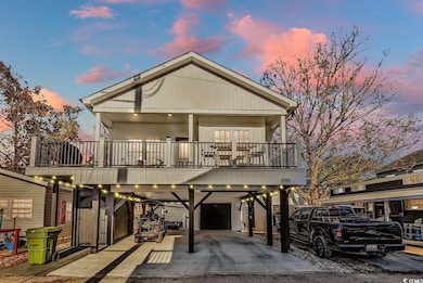 View of front of home with a carport, a garage, an