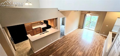 Unfurnished living room with light wood-type flooring, a ceiling fan, baseboards, and a sink