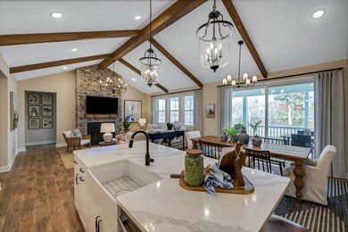 Kitchen with stained ceiling beams & vaulted ceiling