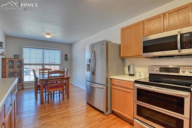 Country eat in Kitchen featuring a textured ceilin
