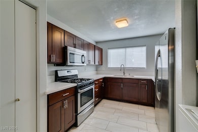 Kitchen with stainless steel appliances and quartz