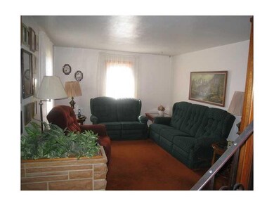 Living Room. The living room features carpeting (h