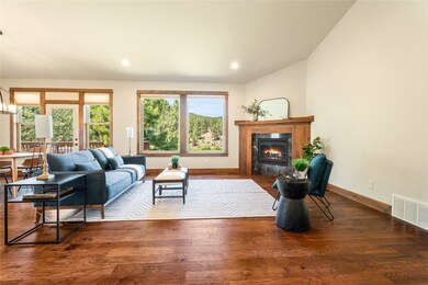 Living room featuring a high end fireplace, wood finished floors, recessed lighting, and lofted ceiling
