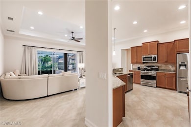 Kitchen featuring ceiling fan, sink, a raised ceil
