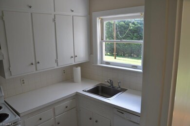 The kitchen features new sink fixture and a lovely view of the private back common area. Mature trees complete the landscape.