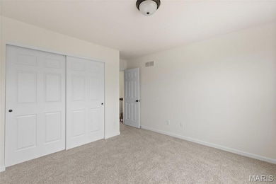Unfurnished bedroom featuring carpet flooring and a closet