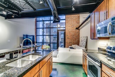 Kitchen featuring tasteful backsplash, dark stone 