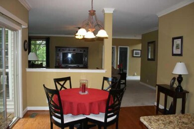 Eat-in kitchen overlooking sliding glass doors leading onto backyard deck. 