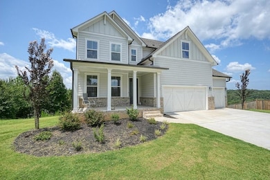 Craftsman house with a front lawn and covered porc