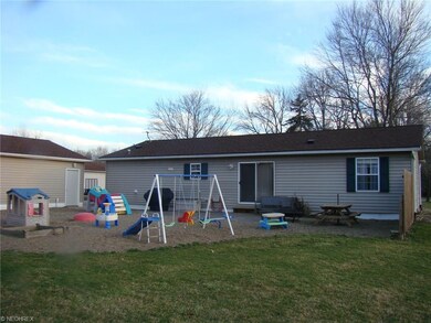 Pea gravel play yard. Side view of garage