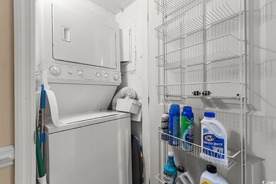 Laundry area featuring stacked washer and dryer