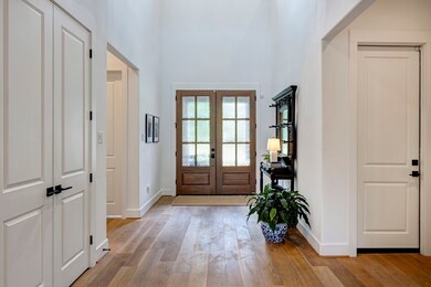 The foyer features a soaring 2-story ceiling and i
