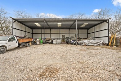 View of pole building featuring a carport and grav