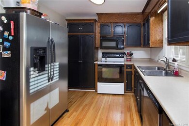 Kitchen with painted cabinets - refrigerator stays