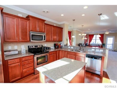 Alternate view of kitchen looking into formal dining room and family room.