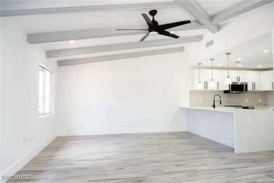 Kitchen with light countertops, stainless steel mi