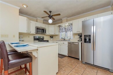 Kitchen with countertop seating; Appliances included