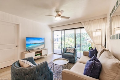 Living room featuring ceiling fan and light hardwo