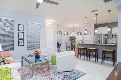 Tiled living room featuring ceiling fan with notab