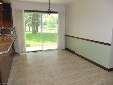 Dinette with ceramic tile floor and slider to pati