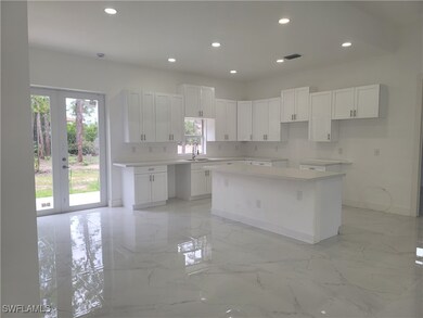 Kitchen with a kitchen island, french doors, reces
