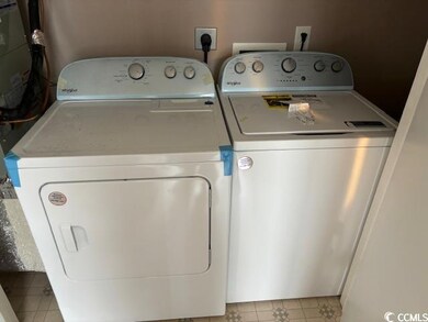 Laundry room with light tile patterned flooring an