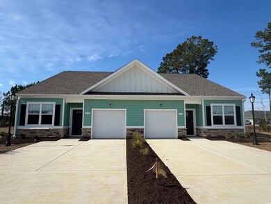 Craftsman-style home with a garage, driveway, a sh