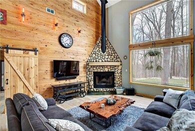 Custom stone wood burning fireplace!  Simonton energy efficient windows frame breathtaking views!