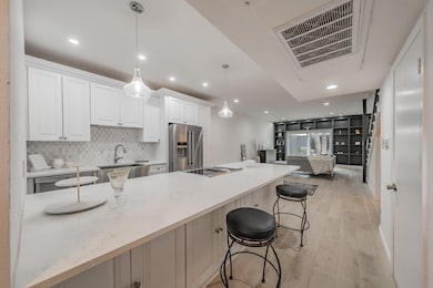 Kitchen featuring light wood finished floors, stai