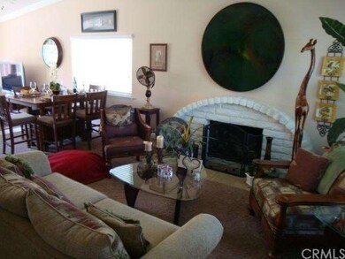 Living room with vaulted ceiling & fireplace