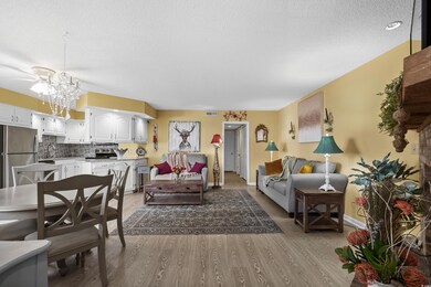 Living room with an inviting chandelier, baseboard