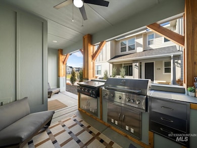 View of patio with a ceiling fan and exterior kitchen