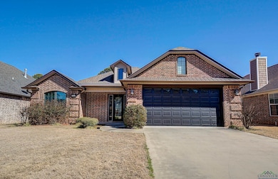 View of front of home featuring brick siding, conc