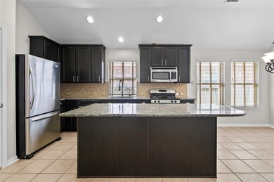 What will you cook first in your stunning new kitchen with gorgeous espresso wood cabinetry, granite counter tops, stainless steel appliances and large breakfast bar?
