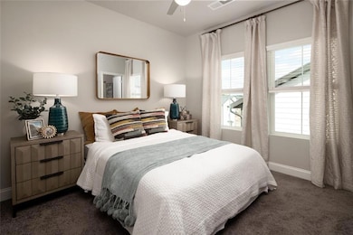 Bedroom featuring dark colored carpet and ceiling 