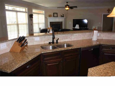 Very open Family Room with gas log fireplace and opens to Kitchen
