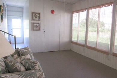 Lanai from carport entrance w/hallway on right to