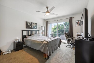 Bedroom with an office area, a ceiling fan, and c