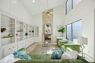 Living room is enhanced by high ceilings and tons