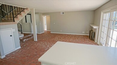 Family room off kitchen with fireplace, opens to backyard