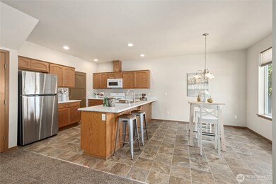 The large light-filled kitchen and dining spaces are bright and inviting.