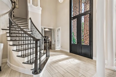 Two-story entry boast gorgeous chandelier, beautiful leaded-glass doors to study and staircase.
