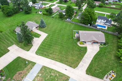 aerial view of property and surrounding area featuring nearby suburban area