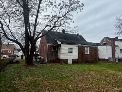 Rear view of property with a yard